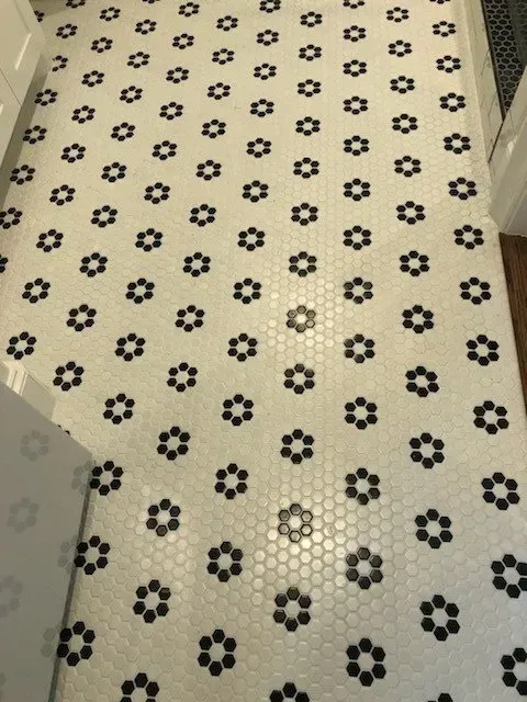 Black and white flower pattern tile floor.