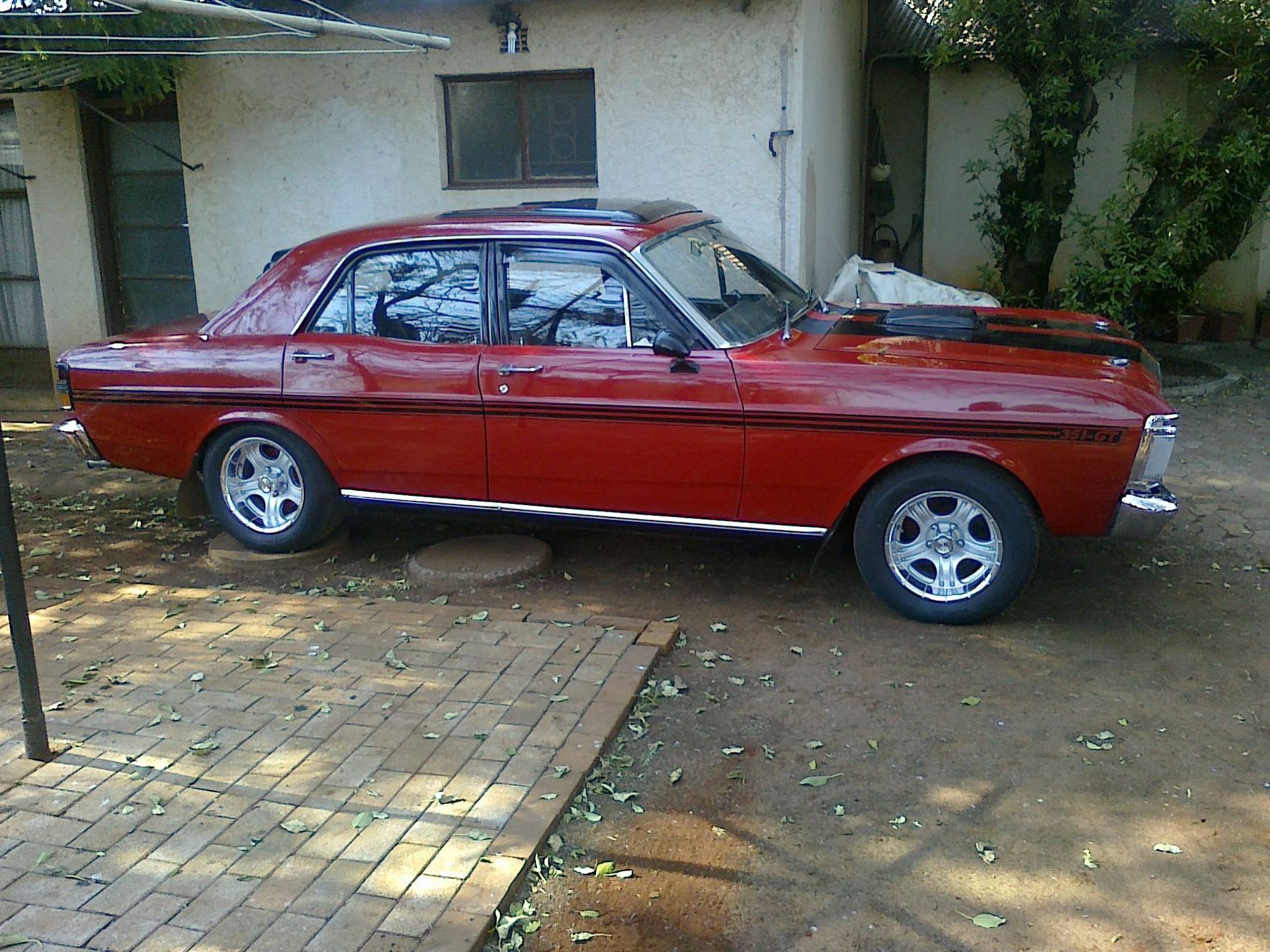 Red Classic Car Parked on Dirt and Brick — Mechanical Care in Belconnen, ACT