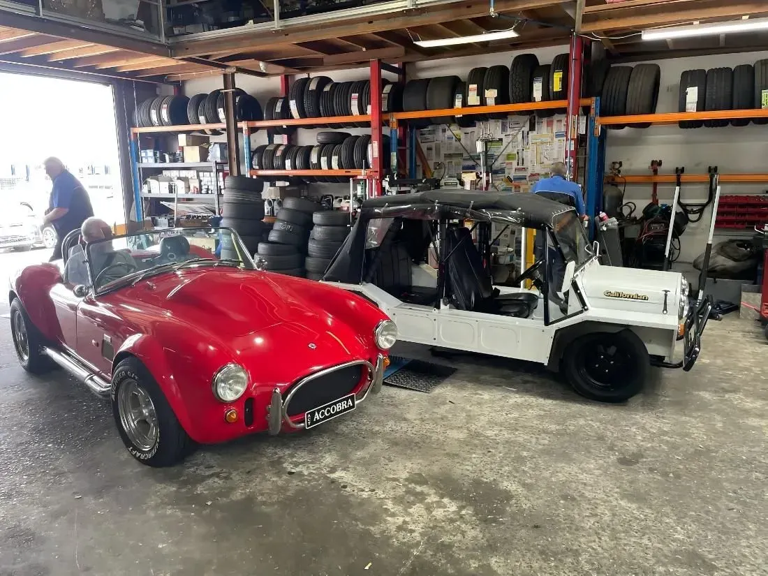 Red Sports Car and White Convertible in a Garage — Mechanical Care in Belconnen, ACT
