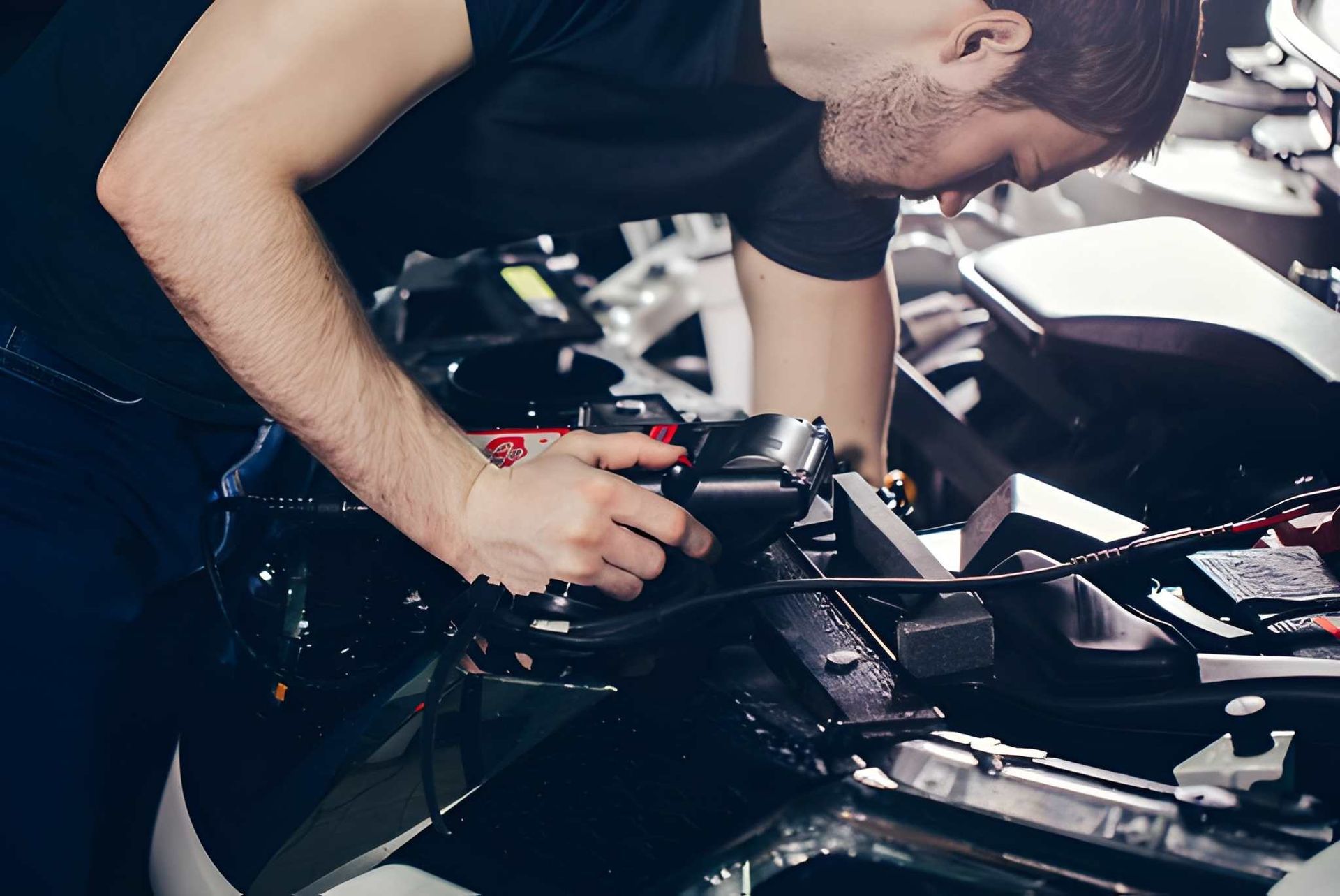 Mechanic Works on a Car Engine Under the Hood — Mechanical Care in Belconnen, ACT