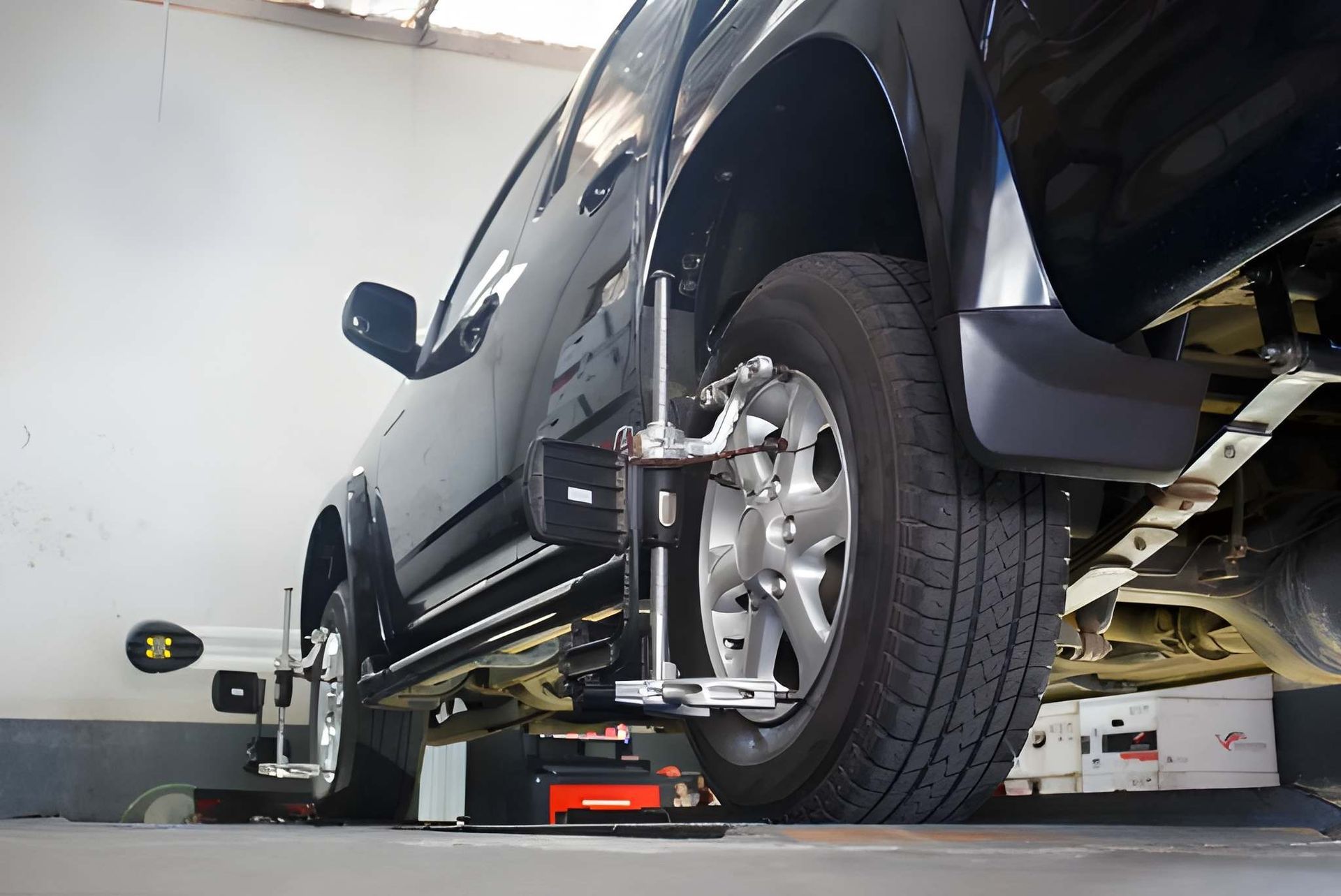 Black Truck on a Car Alignment Machine in a Garage — Mechanical Care in Belconnen, ACT