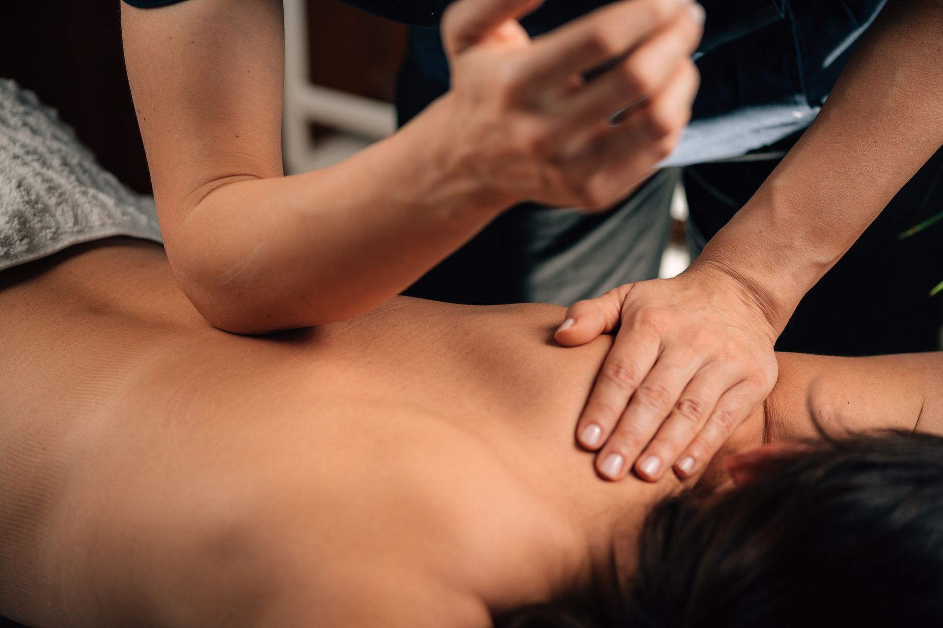 A woman is getting a massage from a man in a spa.