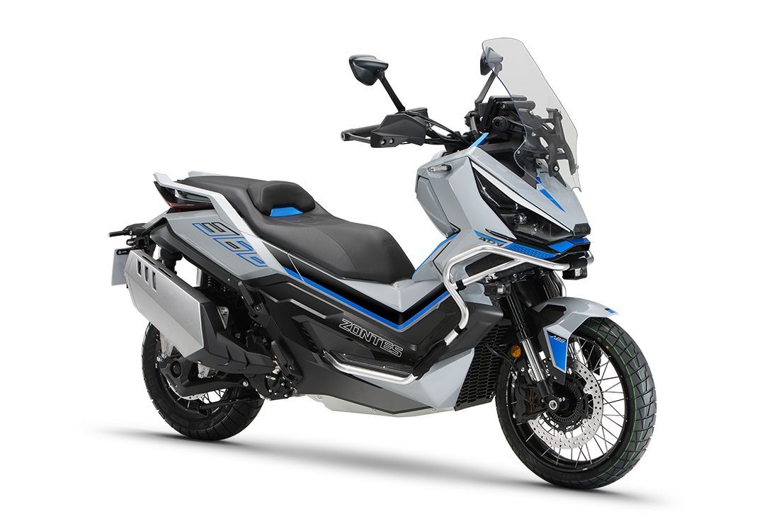 White and blue scooter with black accents, off-road tires, and a windscreen.