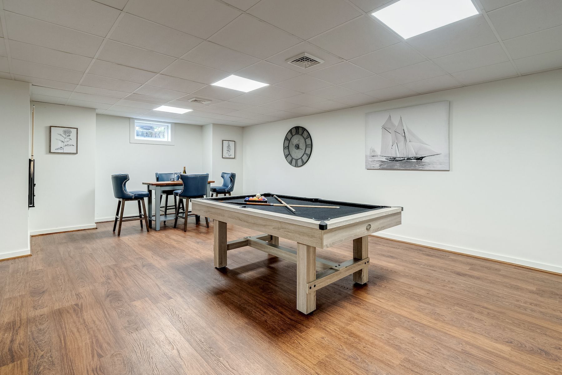 There is a pool table in the middle of the room.