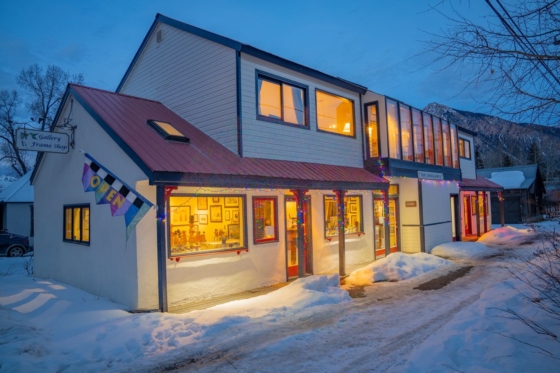 A room with a table and vases and paintings on the wall