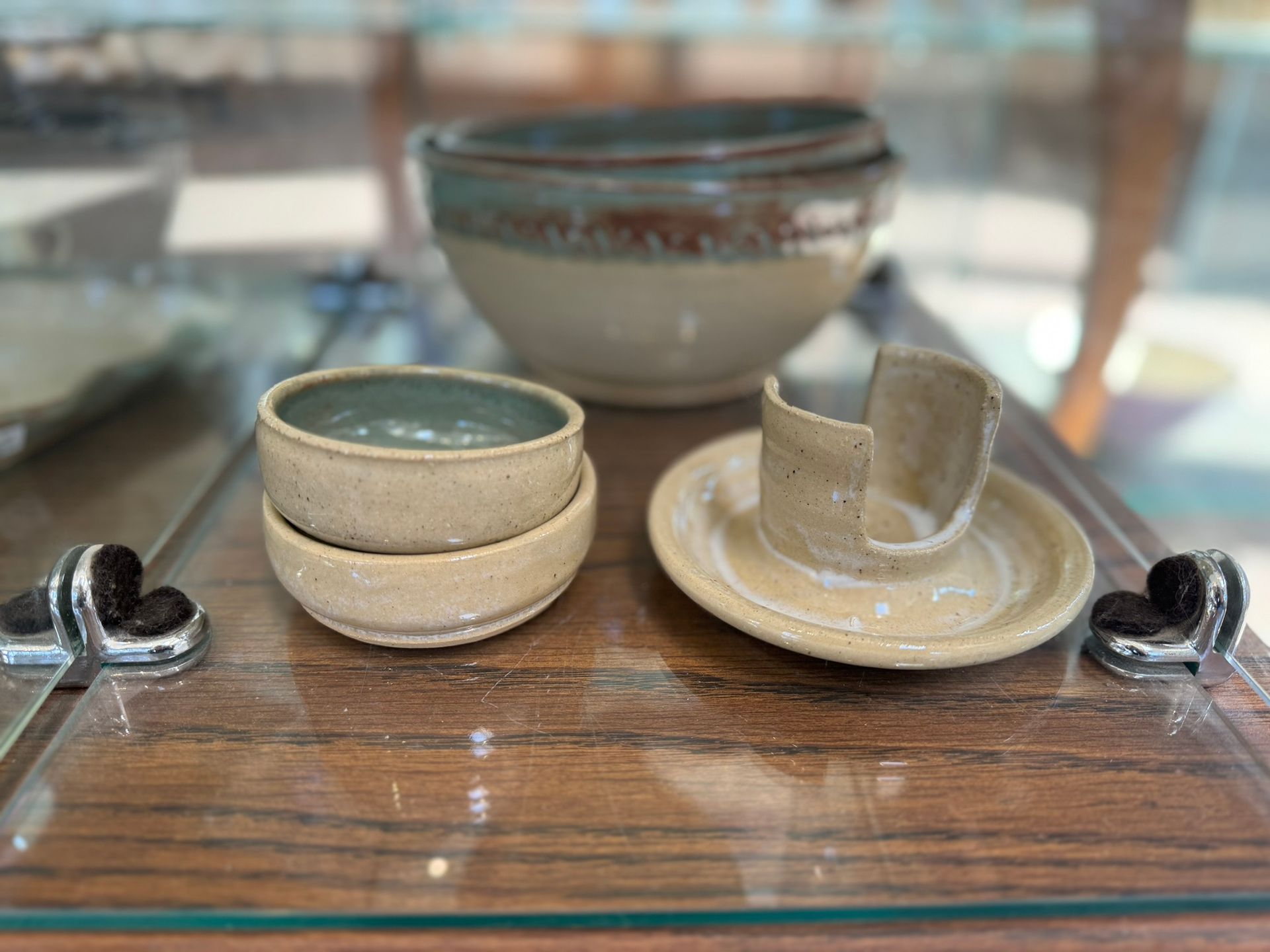 A glass display case filled with ceramic bowls and plates.