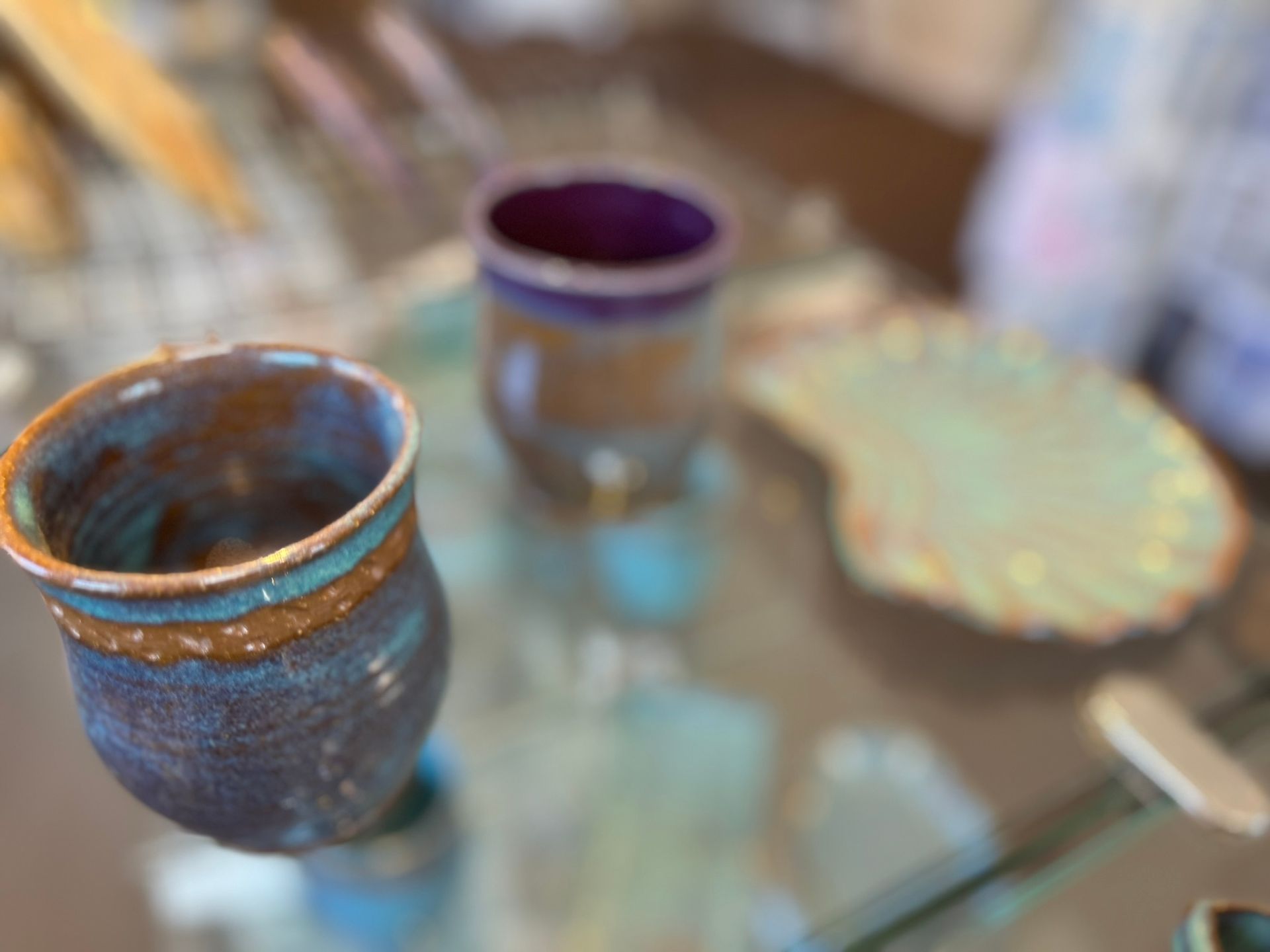 A close up of a ceramic cup on a table.