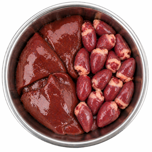 Two supplement capsules beside white and green powder in a metal dog bowl