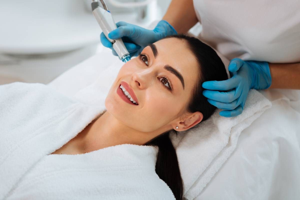 Happy woman receiving a hydrafacial near Lexington, Kentucky (KY)