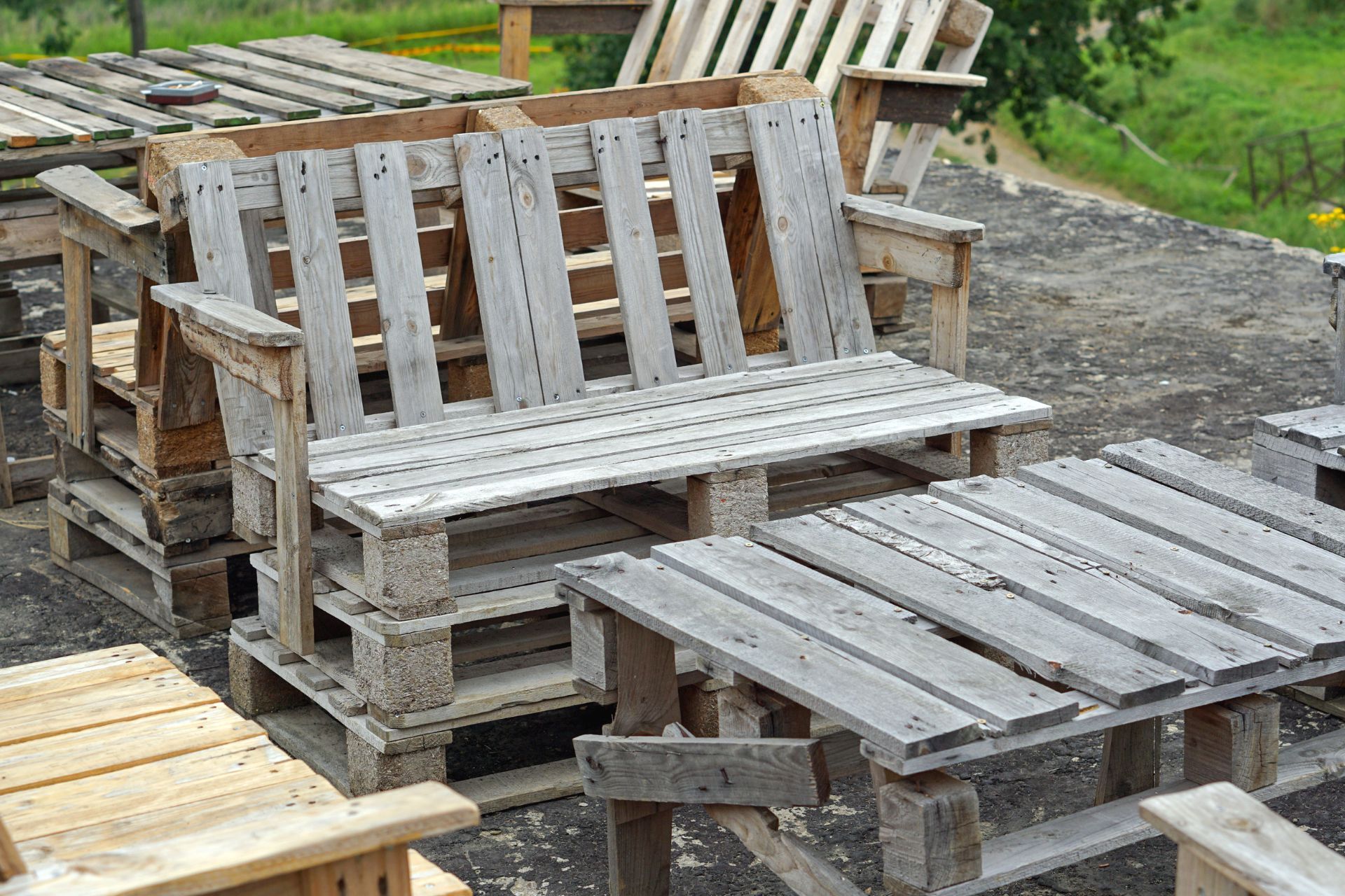 A bunch of wooden pallets are stacked on top of each other.