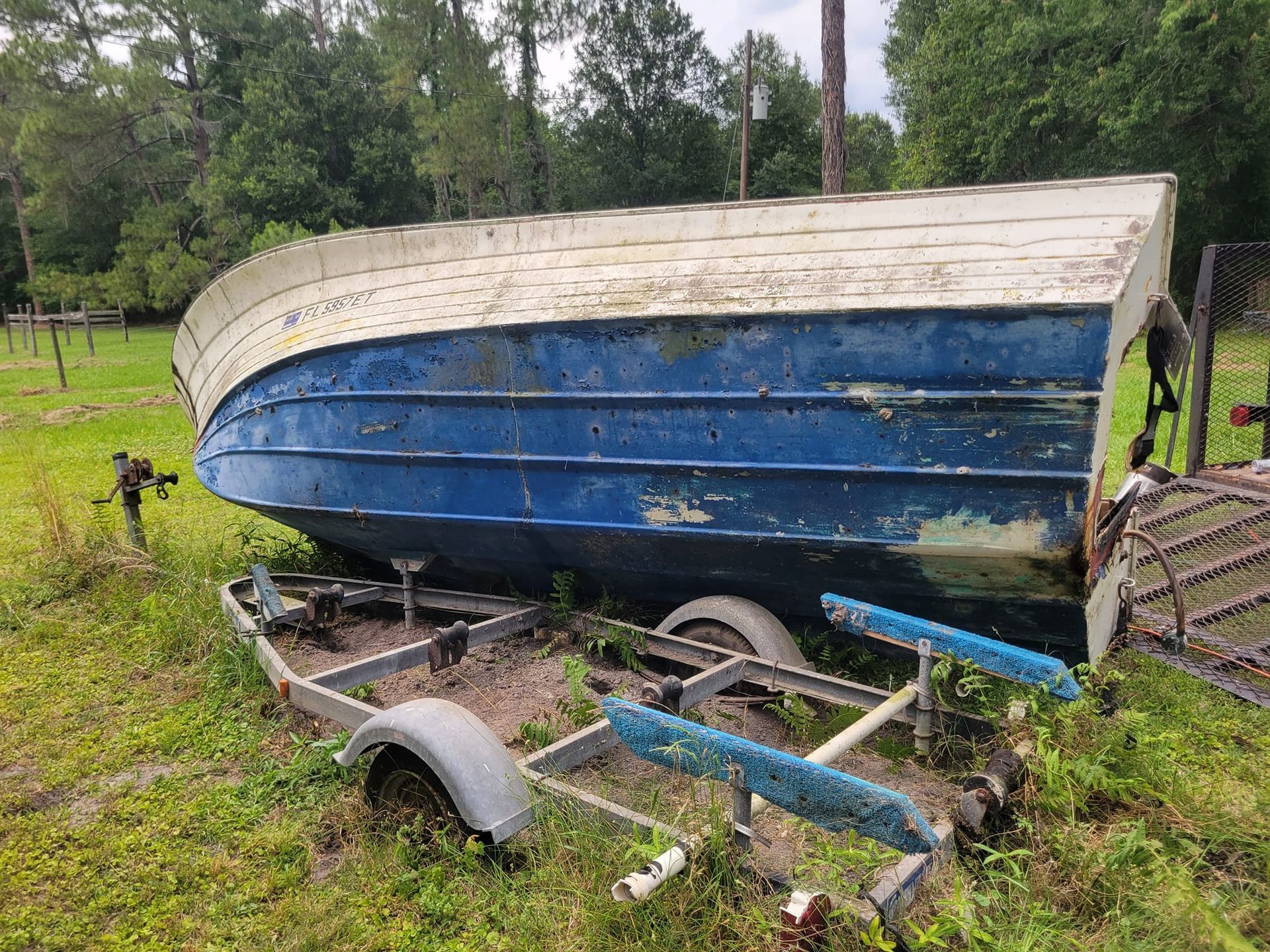 A pile of junk is in front of a container with the number r31 on it