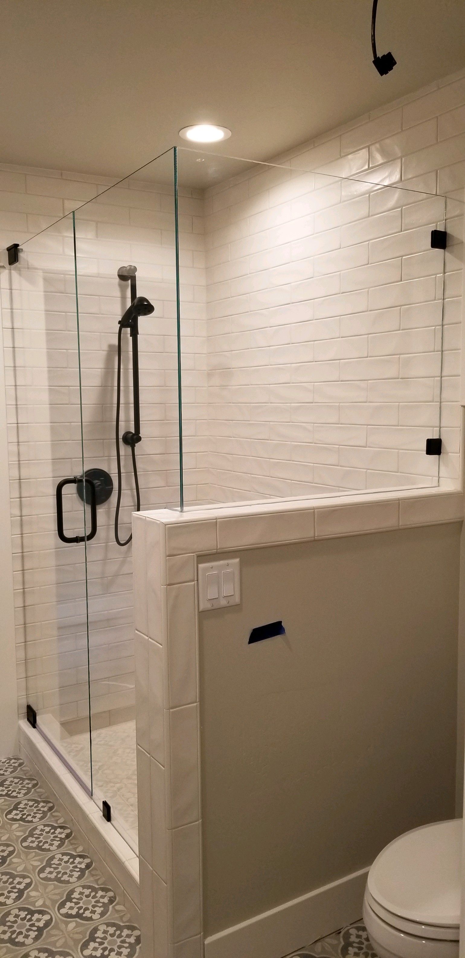 A bathroom with a walk in shower and a toilet.