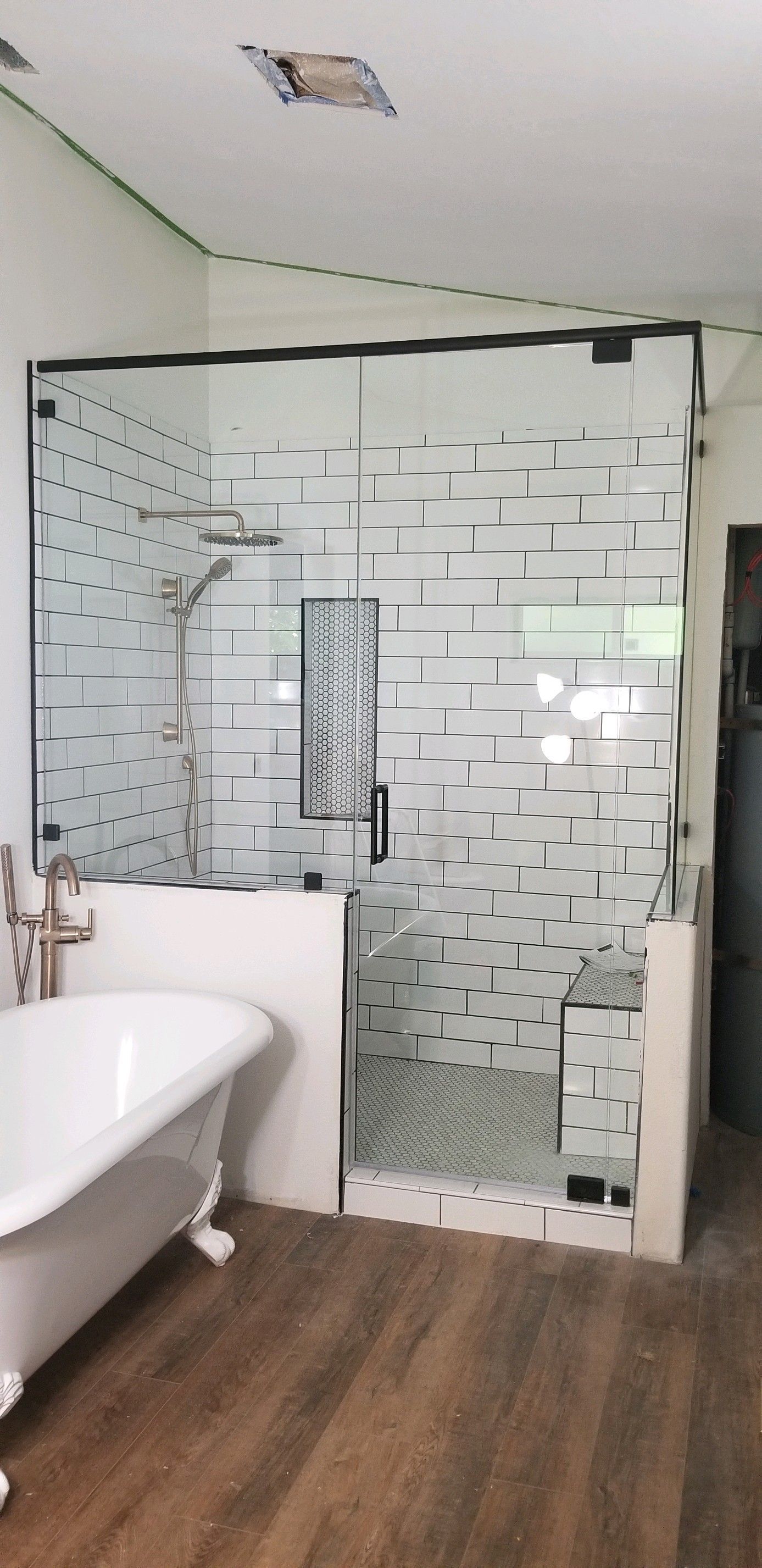 A bathroom with a bathtub and a walk in shower.