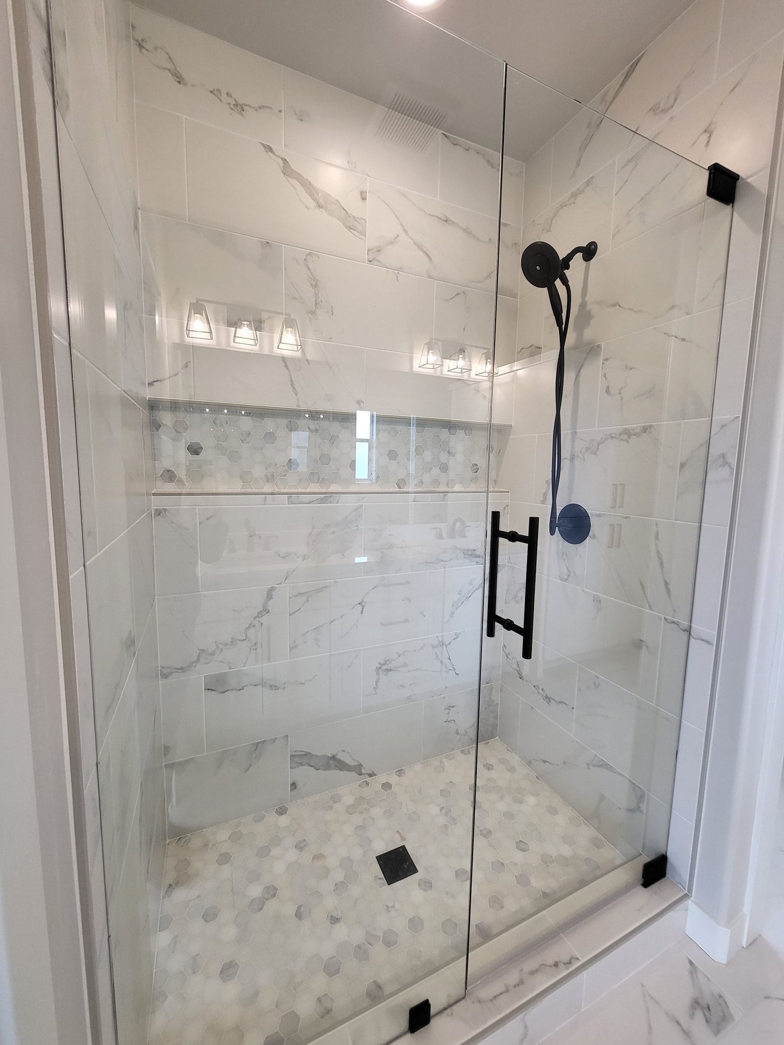 A bathroom with a shower glass door.