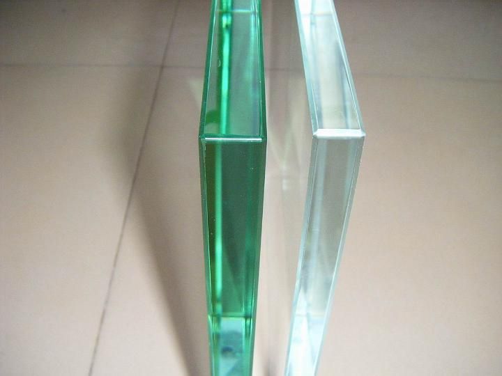 Two pieces of glass are sitting next to each other on a table.