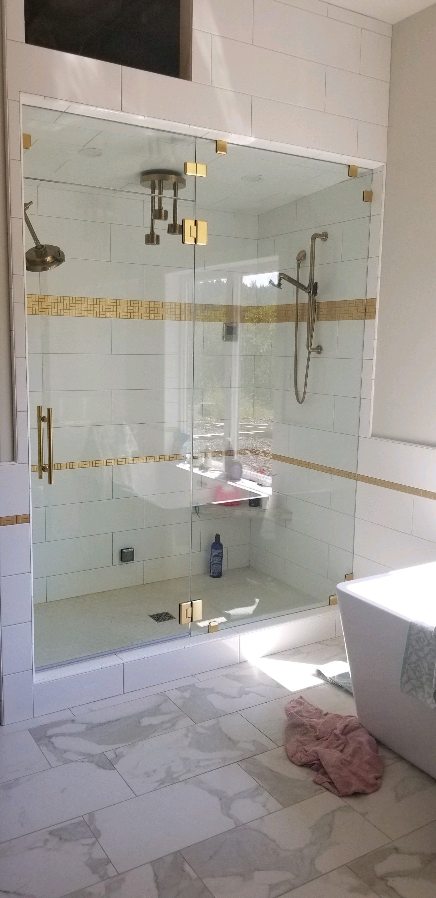 A bathroom with a walk in shower and a bathtub.