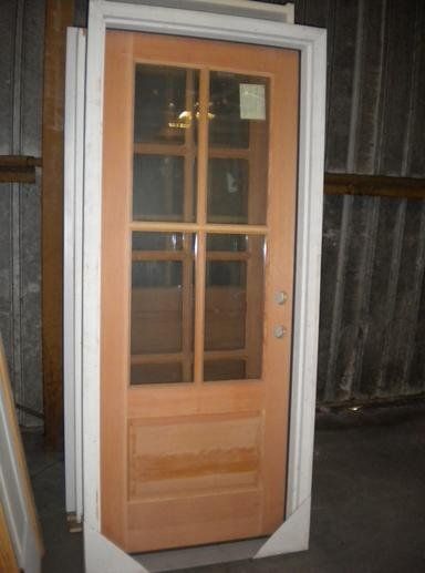 A wooden door with a white frame is stacked on top of each other