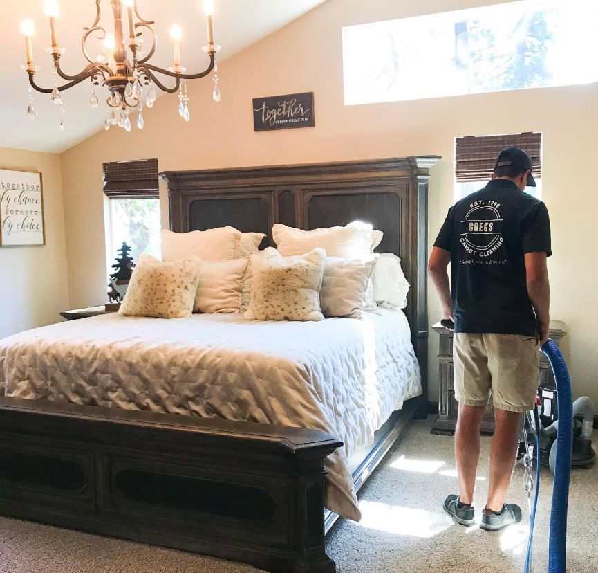 A man standing in front of a bed with a sign on the wall that says truth