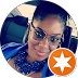A woman wearing glasses and a necklace is in a circle with an orange star.