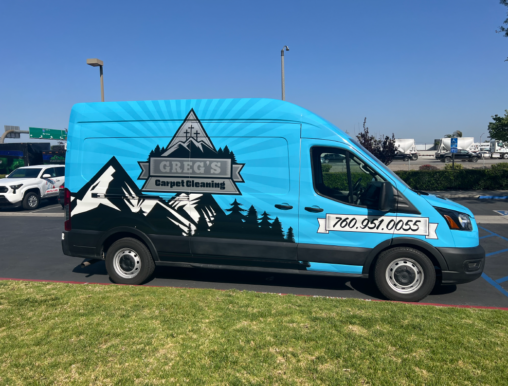 A blue van with a mountain-themed graphic and