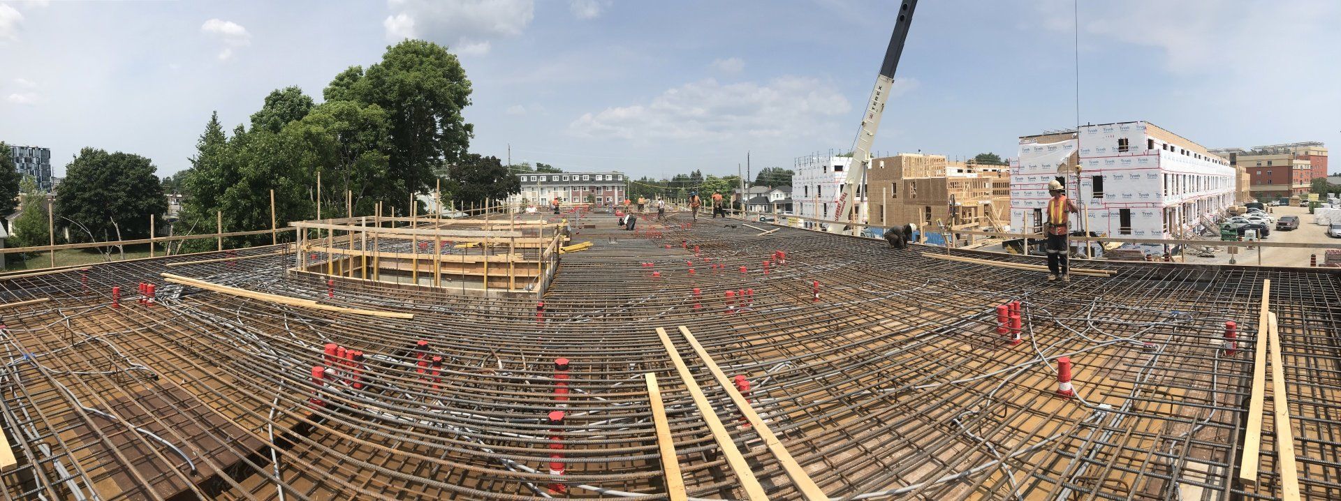 A large construction site with a crane in the background.