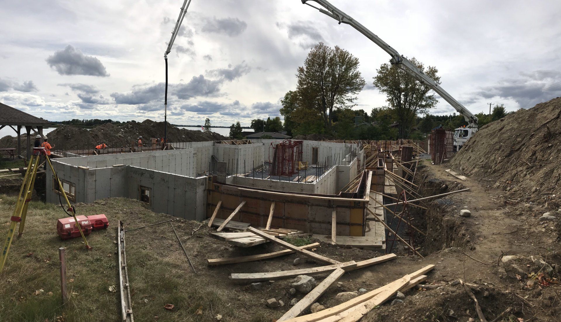 A construction site with a large crane in the background.