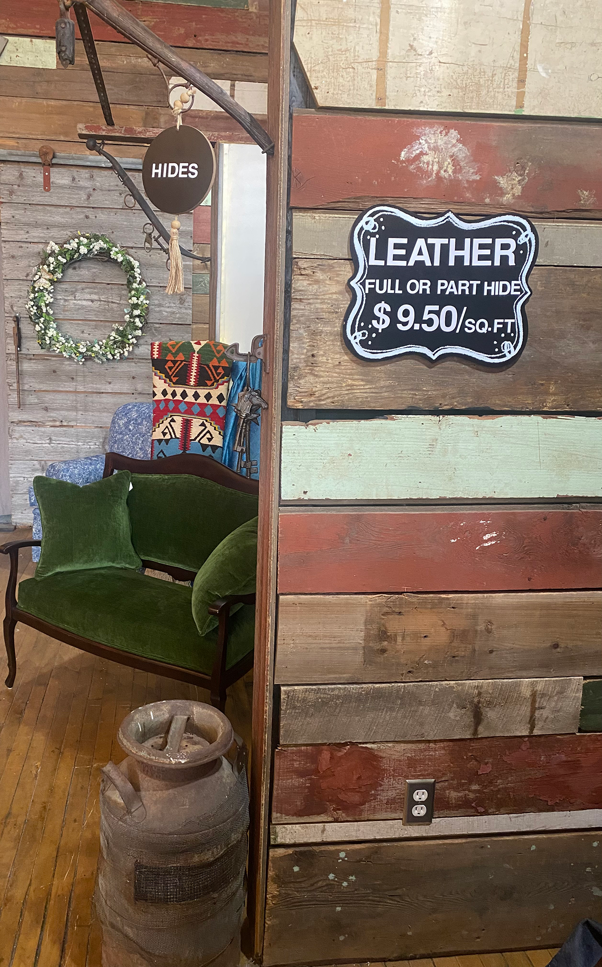 Leather wall with green couch.