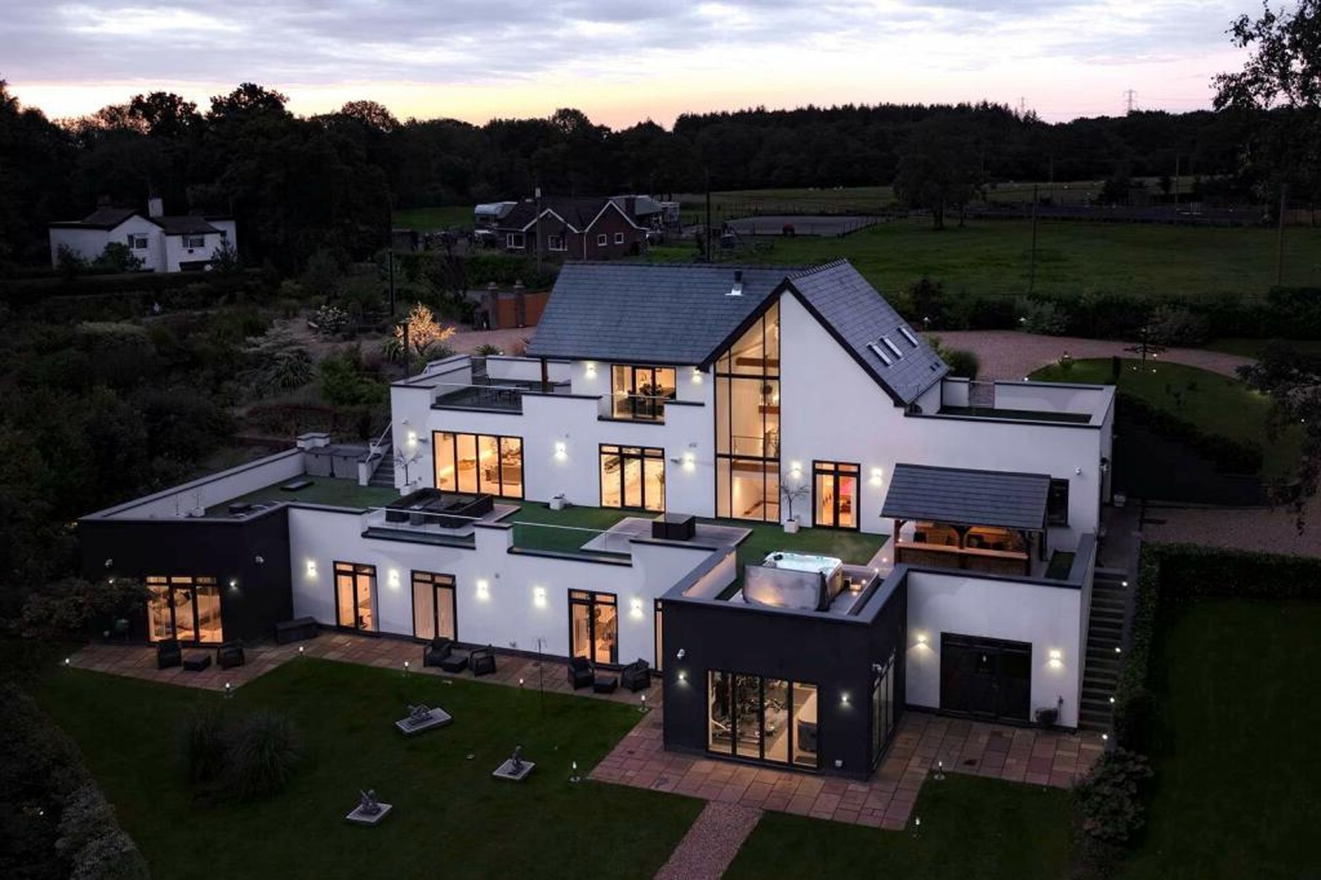 An aerial view of a modern house at dusk.