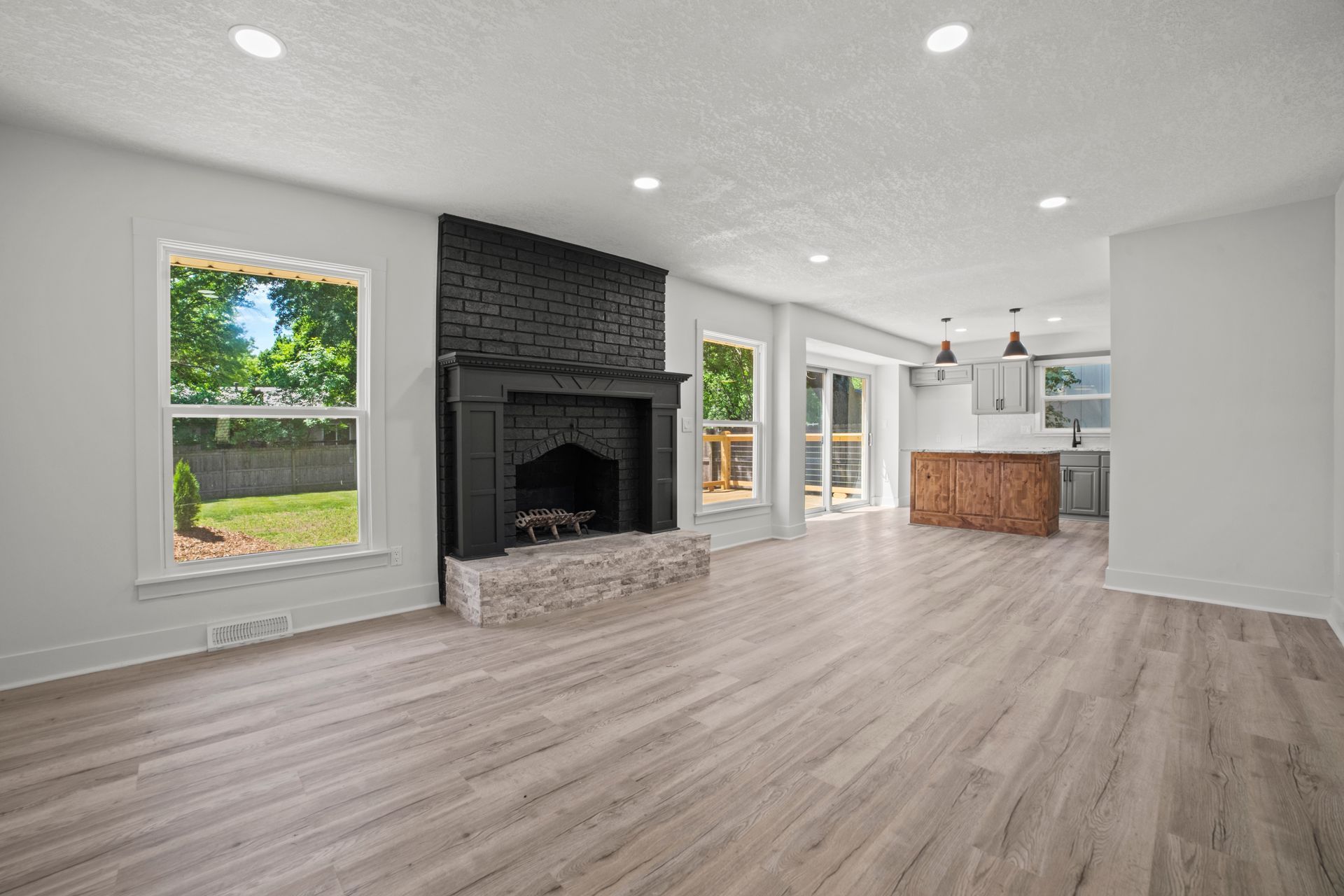 There is a fireplace in the middle of the living room.