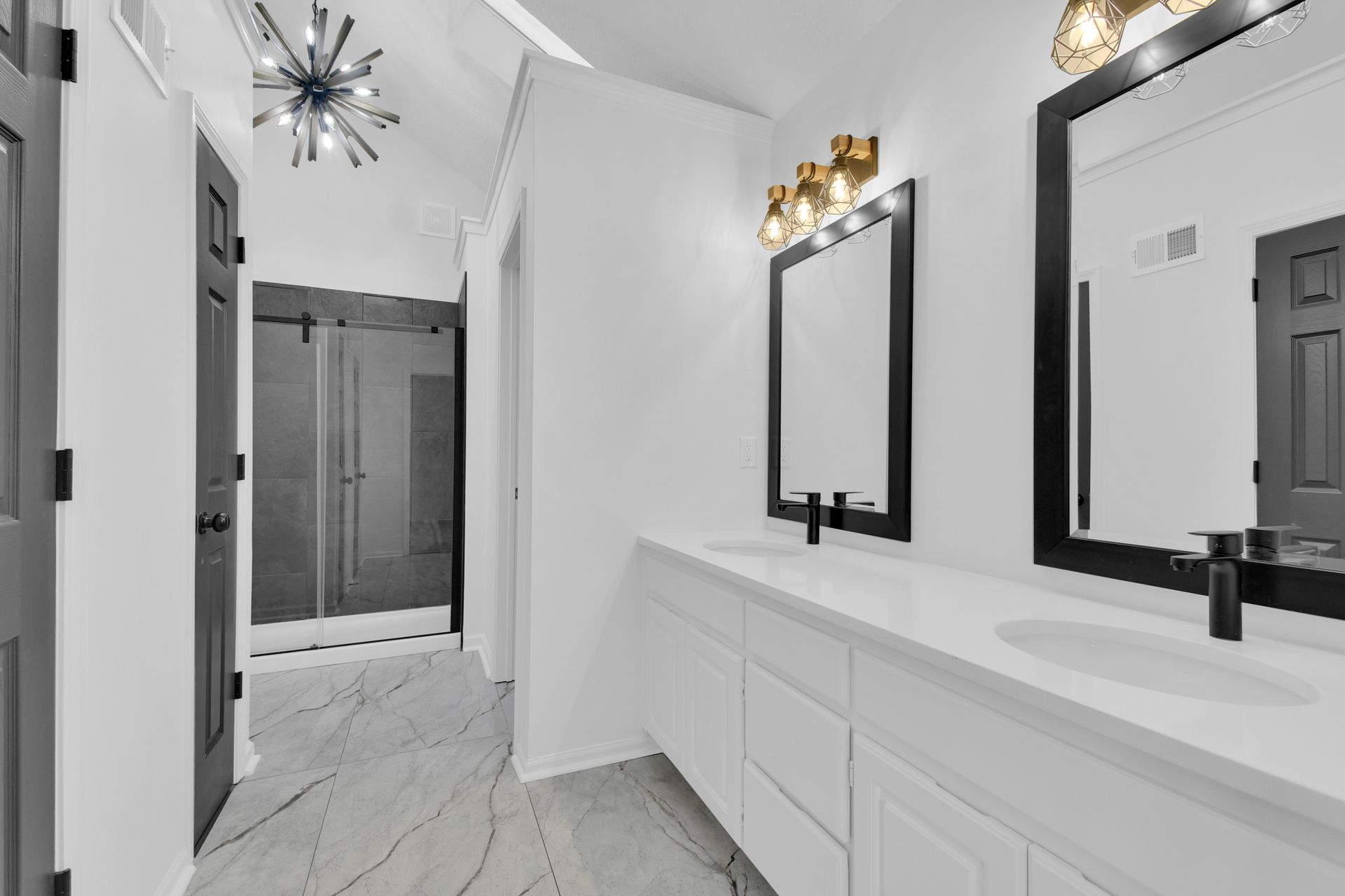 A bathroom with two sinks and two mirrors.