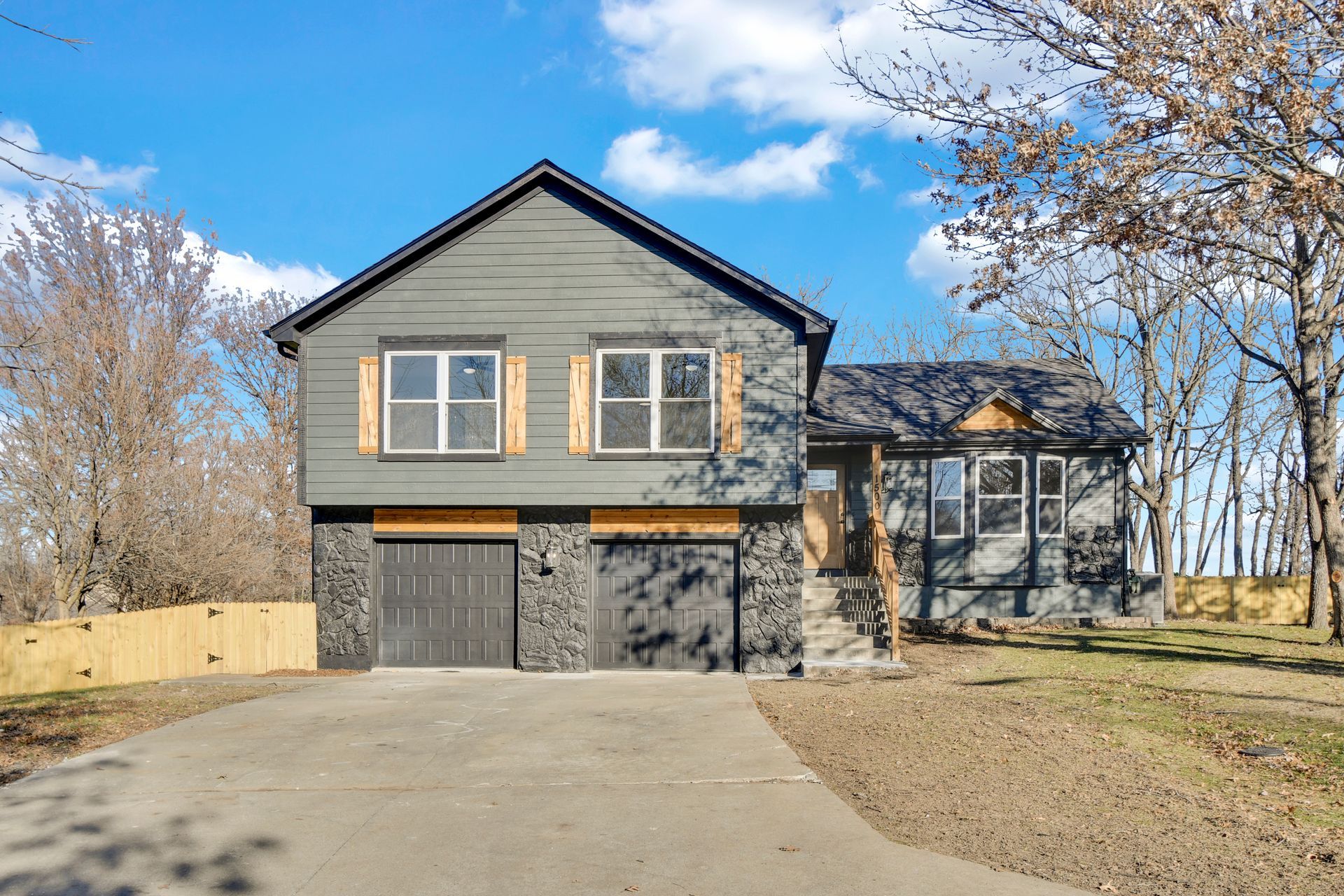 A large house with a garage and a driveway in front of it.