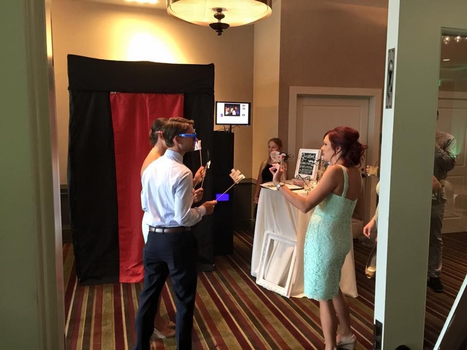 A Group of People are Standing in a Room in front of a Photo Booth — Pinellas Park, FL — Hyde's Professional DJ & Event Services