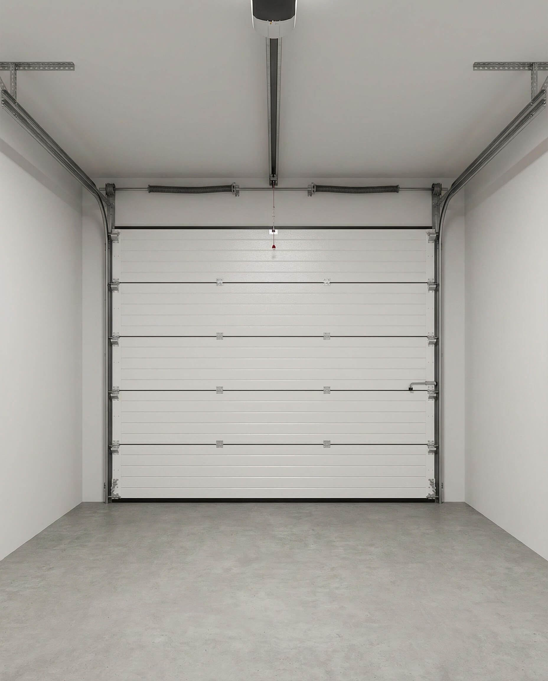 Interior de un garaje blanco con puerta superior blanca cerrada. Suelo gris y paredes blancas.