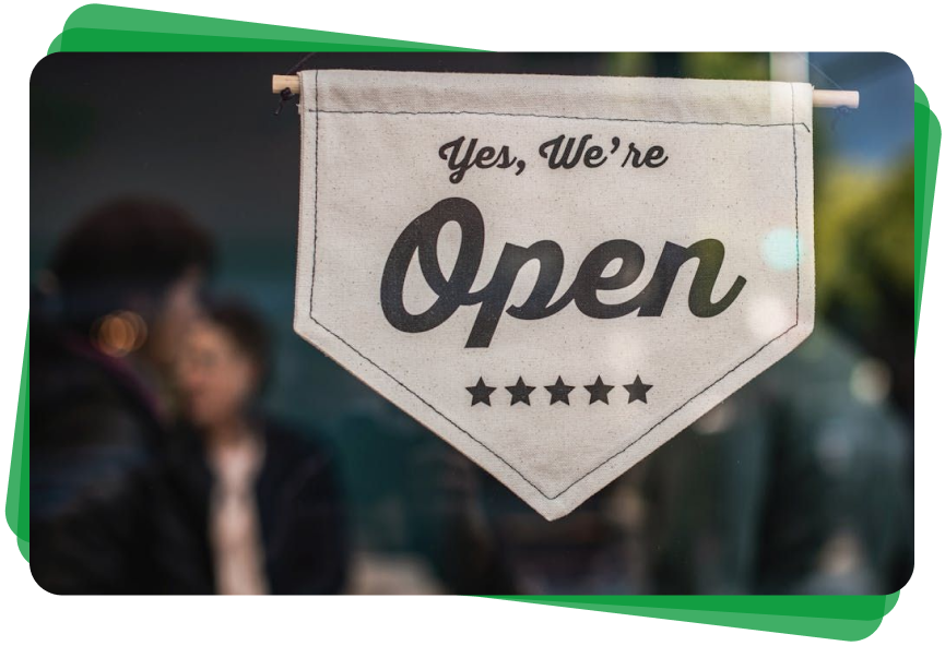 A sign that says `` yes , we 're open '' is hanging on a window.