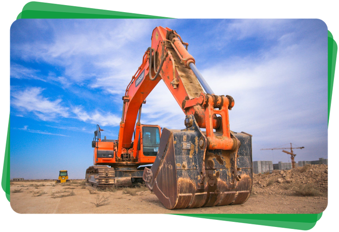 A large orange excavator is sitting on top of a dirt field.