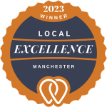 It is a badge that says local excellence manchester.