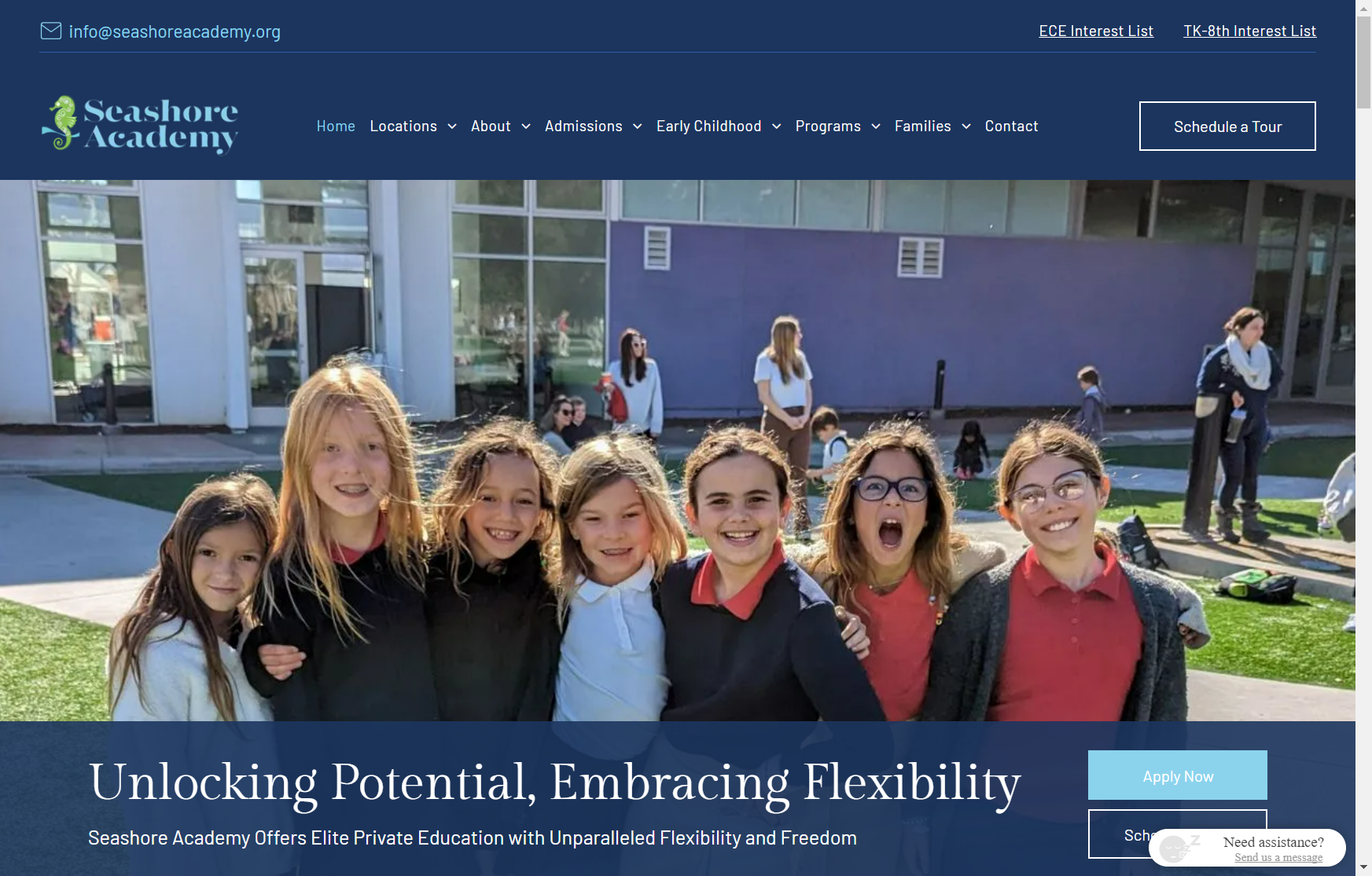 A group of children are posing for a picture in front of a building.