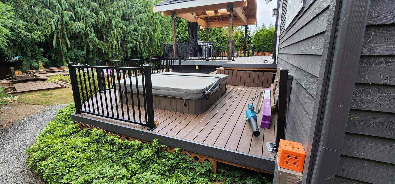 There is a hot tub on the deck of a house.