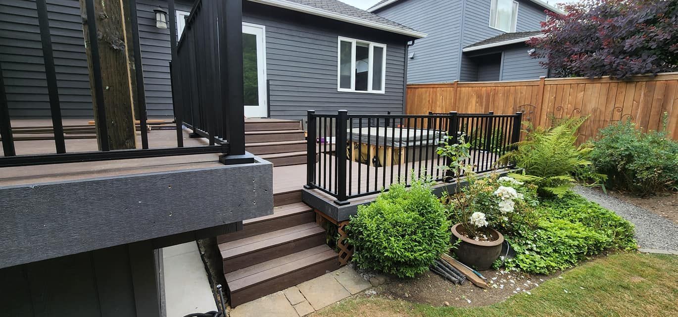 A house with a deck and stairs in the backyard.