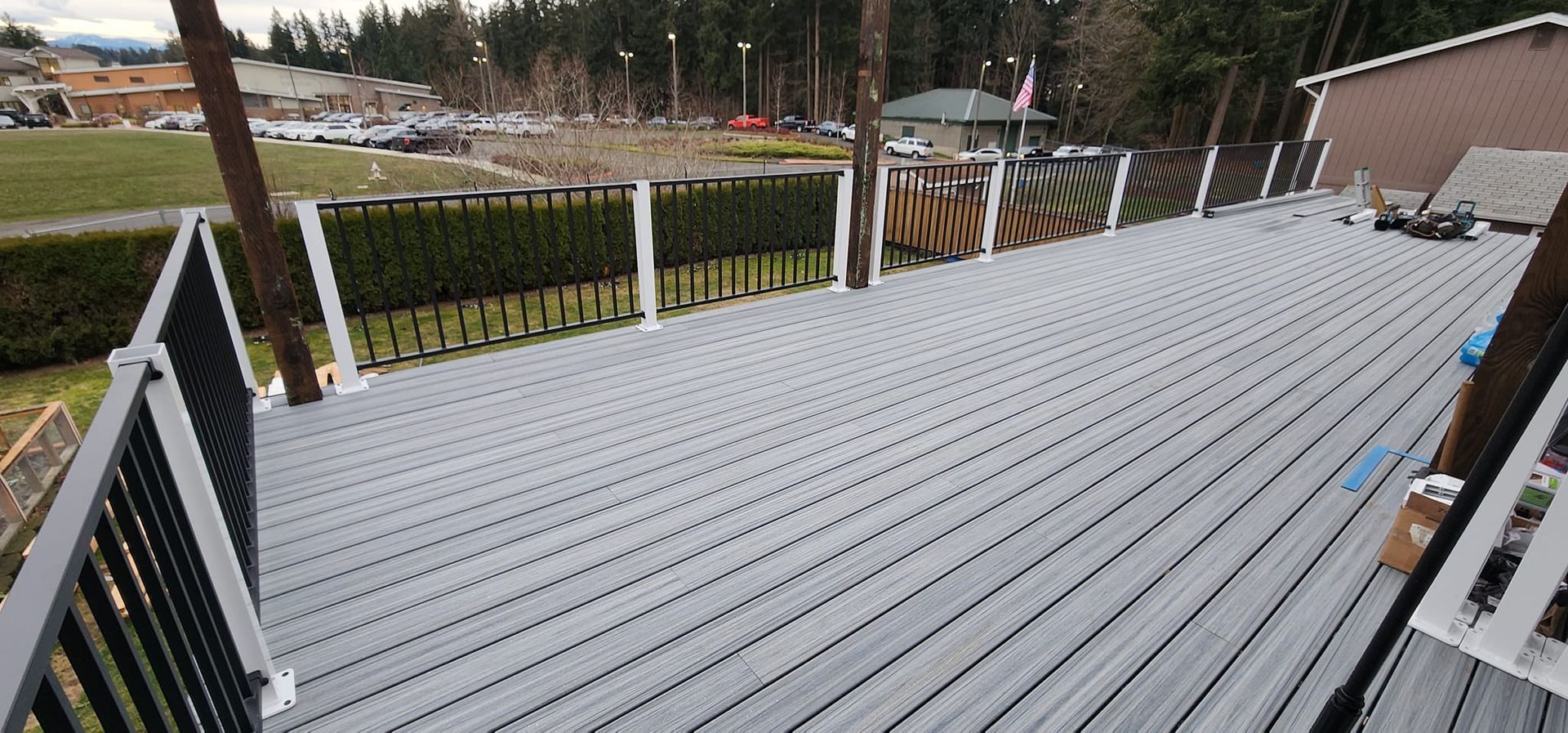 A large deck with a railing and stairs leading up to it.