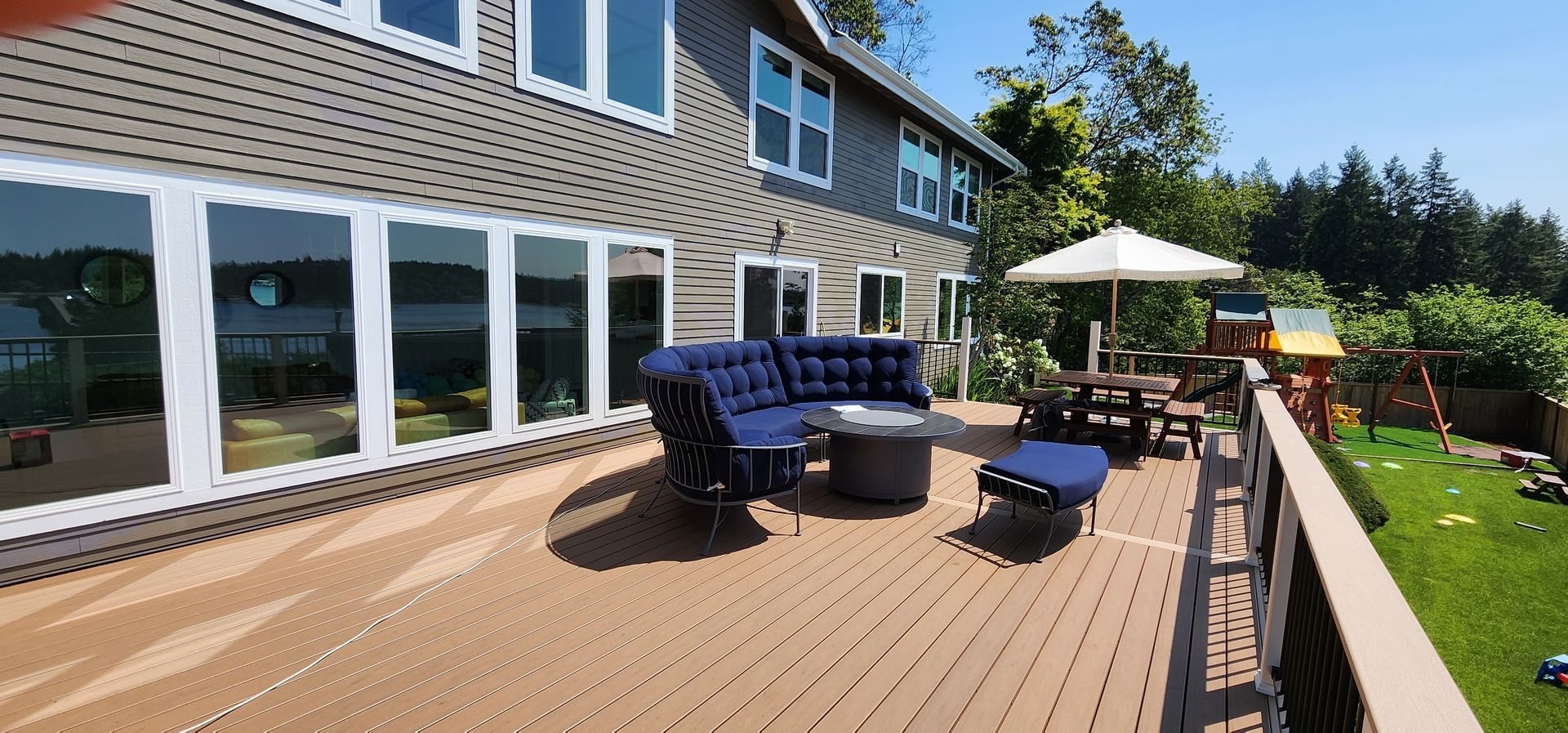 There is a large deck with a lot of furniture on it.