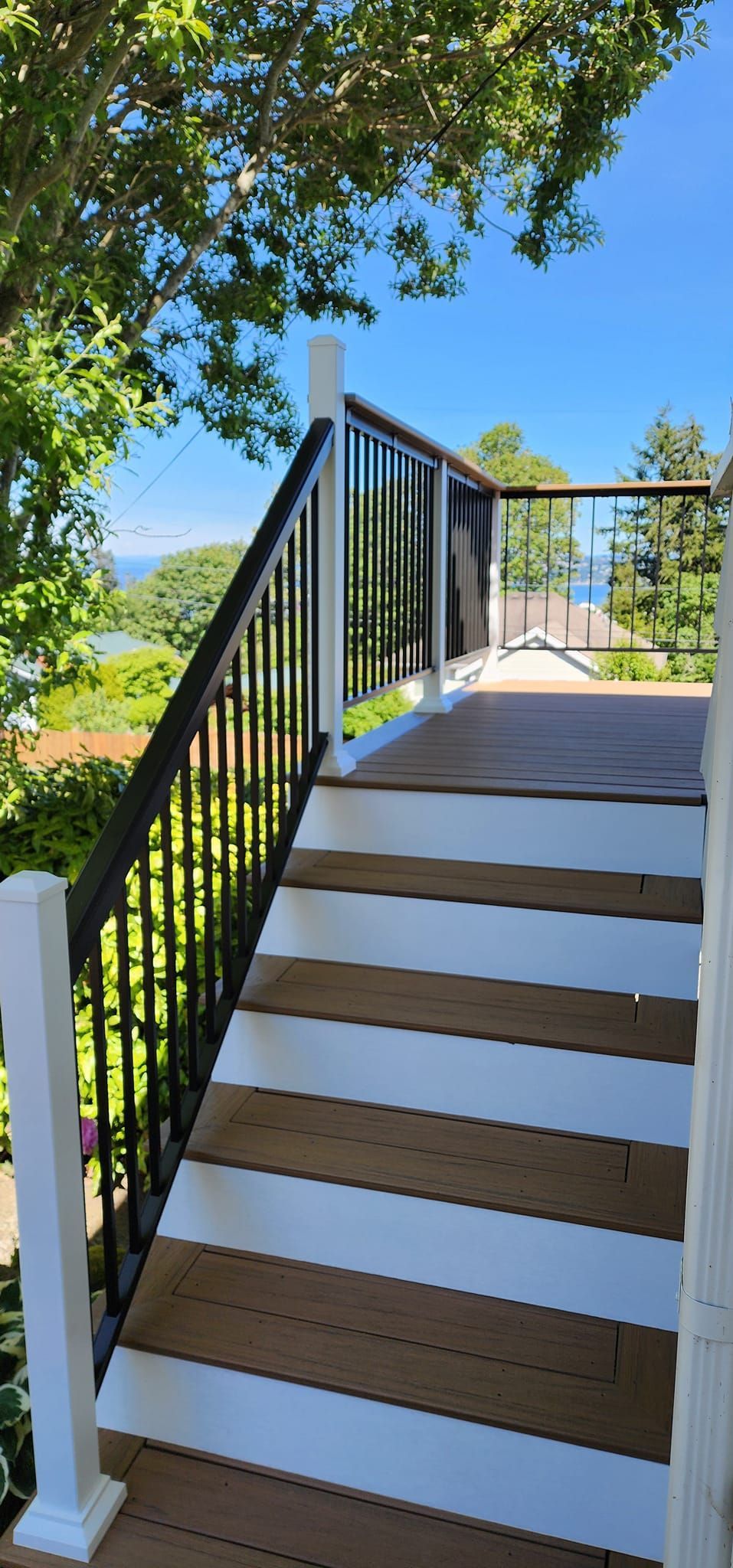 A set of stairs leading up to a deck with a view of the ocean.