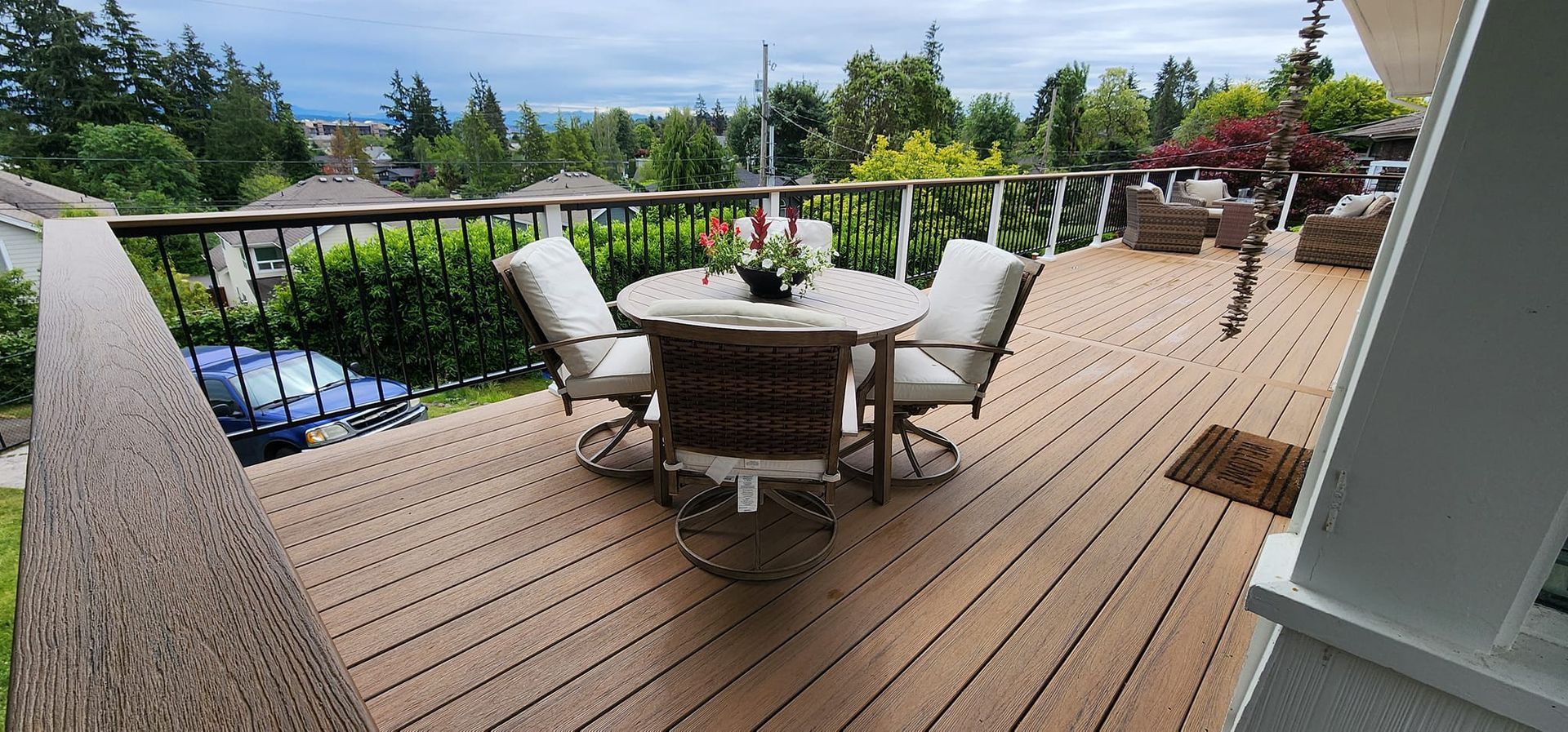 A wooden deck with a table and chairs on it.