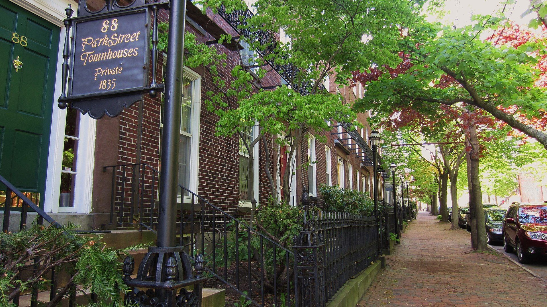 A row of houses on a street with a sign that says 25