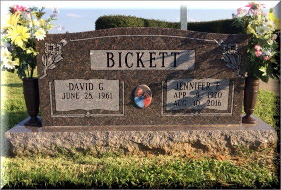 A gravestone for david and jennifer bickett in a cemetery