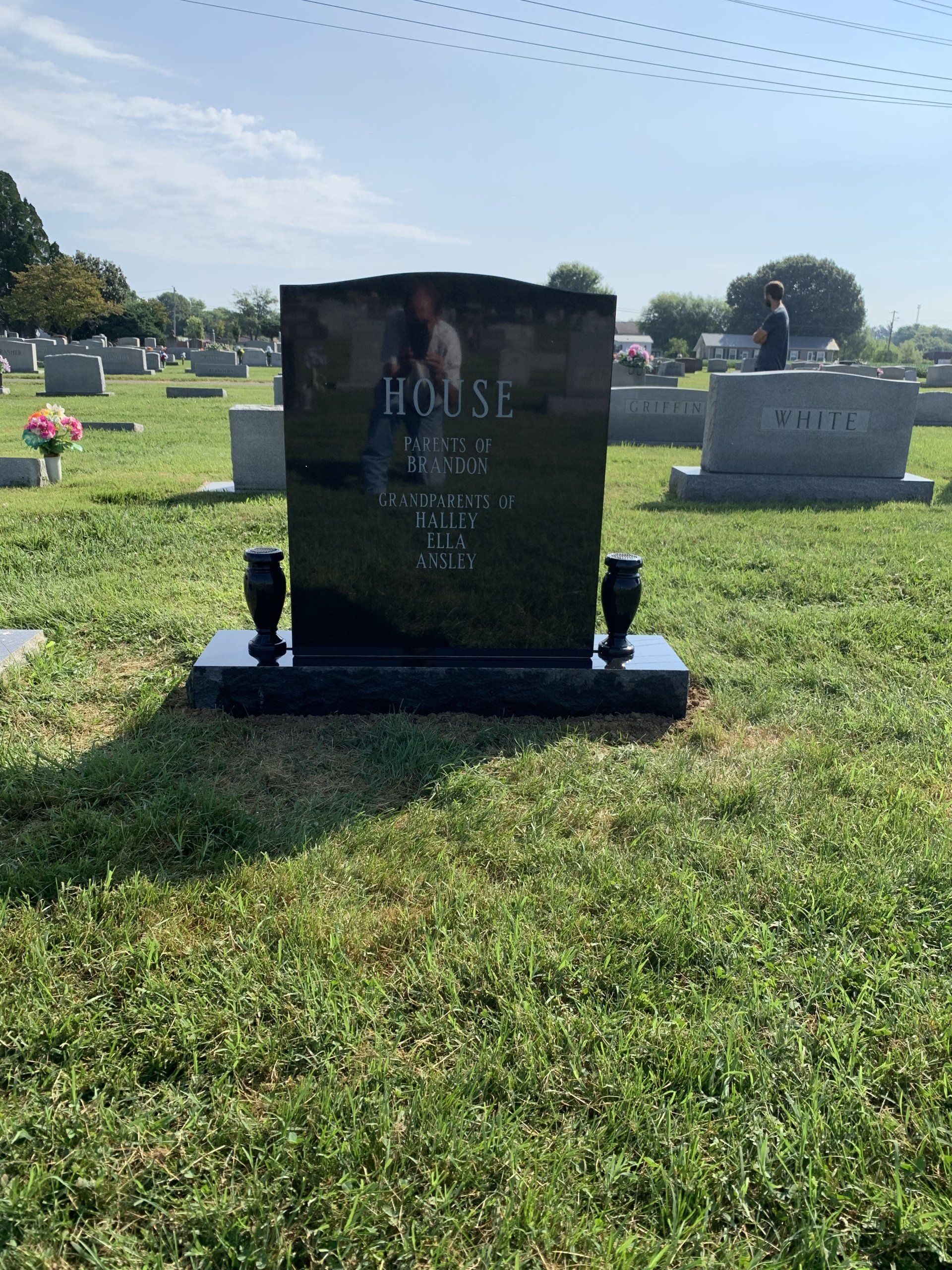 A gravestone in a cemetery with the name rocai on it