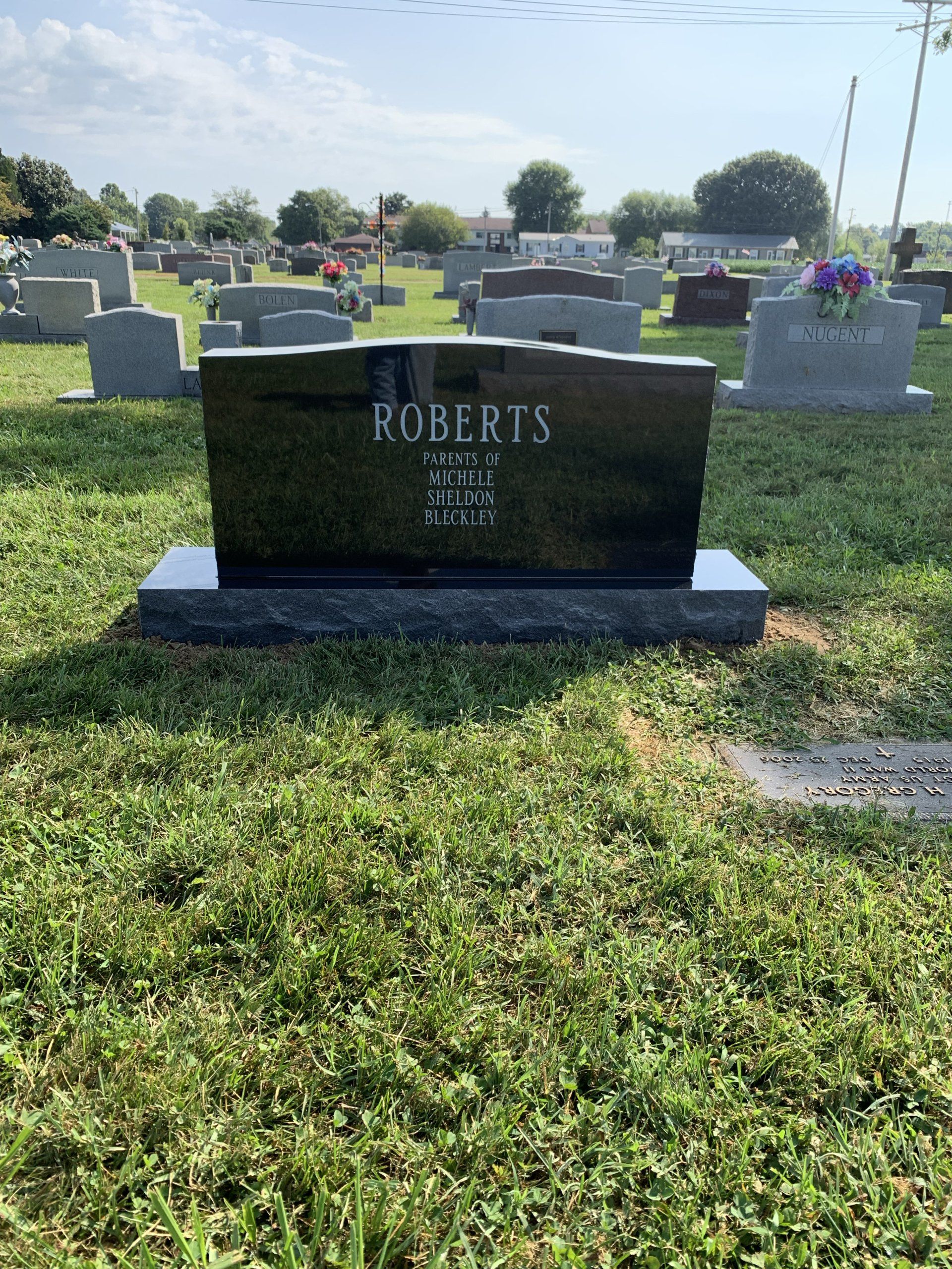 A gravestone in a cemetery with the name roberts on it