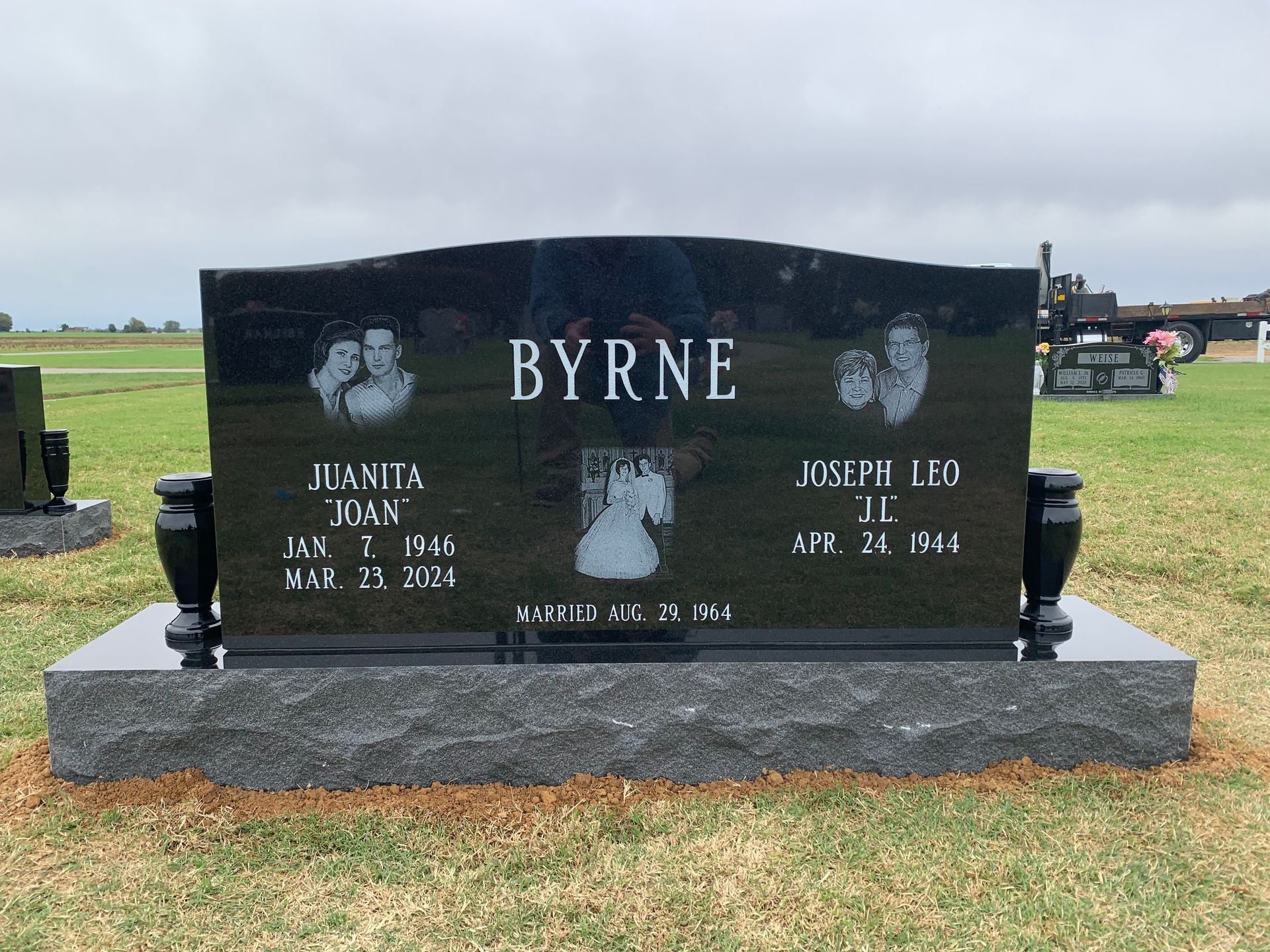 A black gravestone with the name byrne on it