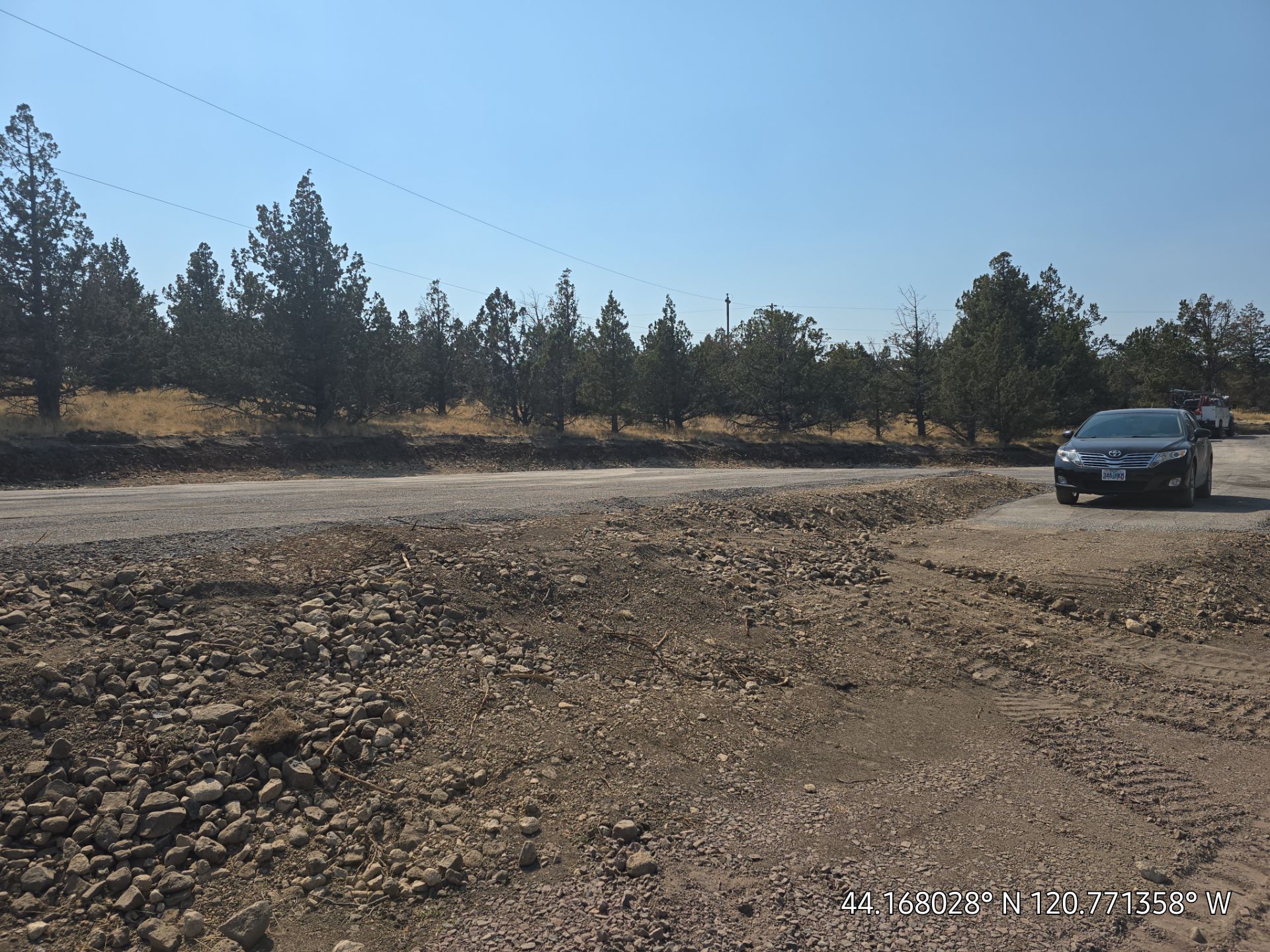 Bobcat skid steer moving dirt at a construction site.