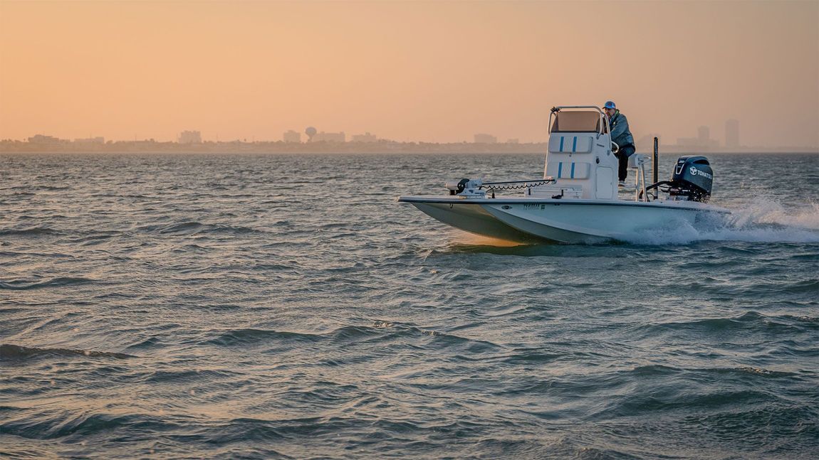 A boat is floating on top of a large body of water.